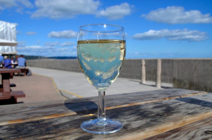 A glass of wine reflecting the clouds